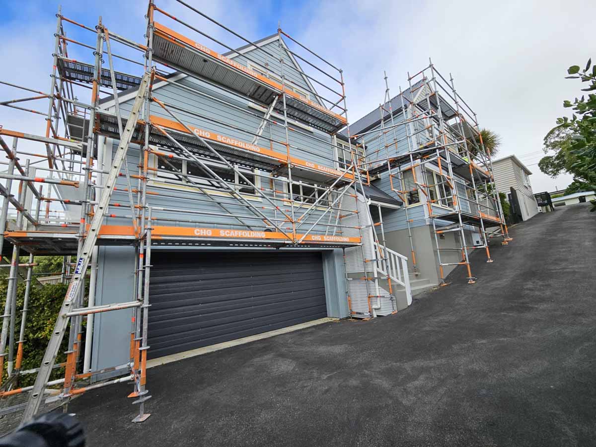 Large scaffolding structure around a commercial building.